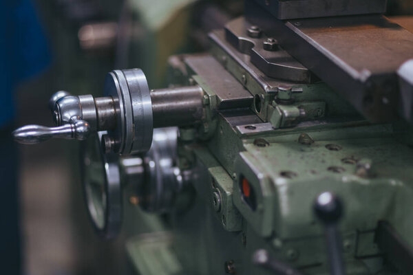 old green lathe in the workshop. old metal lathe machine