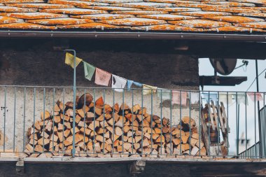 Pontechianle, Italy. Wooden logs stacked on the wall of a mountain house. Mountain Wood clipart