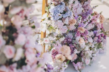 Düğün çiçeği arka planı, taze gül, bir demet çiçek. Bahçe partisi için güllerle çiçek aranjmanı. Dışarıda güzel bir düğün töreni düzenlendi..