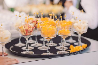 Delightful fruit cups showcase vibrant colors at a summer outdoor gathering in a sunny garden setting during the afternoon