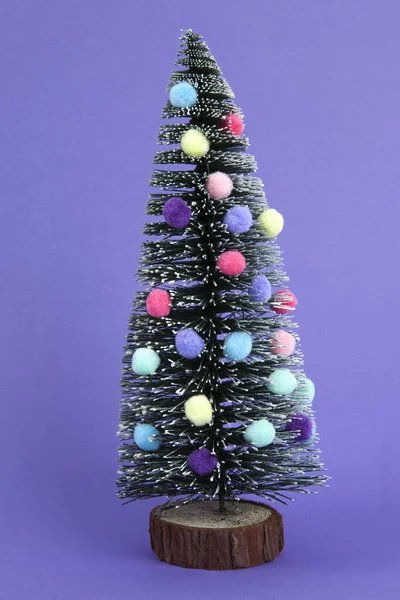 Miniature Christmas Tree Decorated Mini Garlands Pompoms Baubles Violet Background — Stock Photo, Image