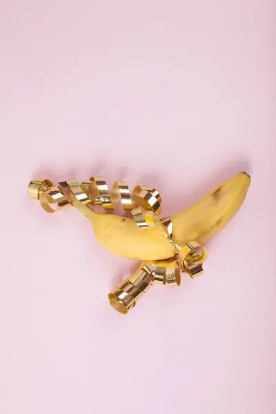Una Banana Matura Avvolta Nastro Arricciato Dorato Come Fosse Dono — Foto Stock