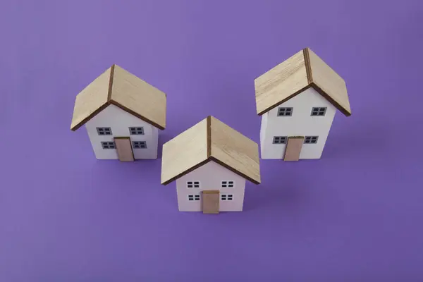 Group Miniature Houses Lined Bright Purple Background Vivid Colors Minimal — Stock Photo, Image
