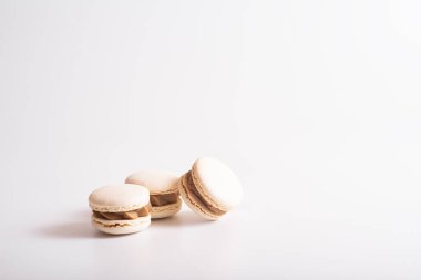 White macaron cookies. Isolated on white background. Tasty dessert. Pyramid of macaroons. Sweet delicious. Front view