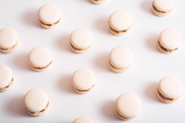 Tasty sweet macarons. Macaroons on white background. Pattern of macaroons. Delicious dessert. Text place