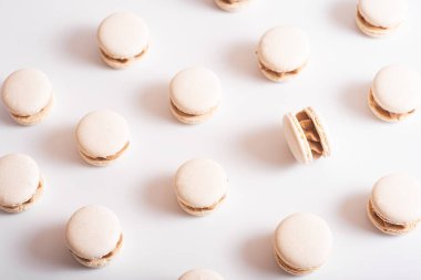 Macaroons pattern Top view photo for posters, banners and wallpapers on white background. All the same and one different. High resolution