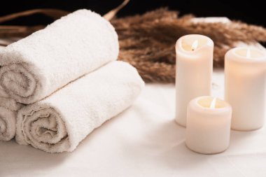 Spa still life with aromatic candles,oils and towel. Dark background. massage content. Massage room. spa advertising