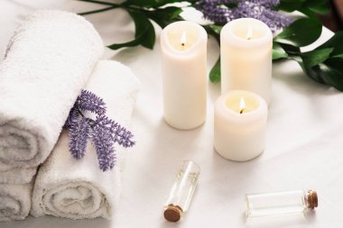 Spa still life with aromatic candles,oils and towel. Dark background. massage content. Massage room. spa advertising