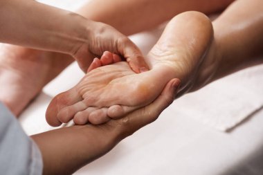 Masseur doing hand massage with oil in spa salon. Spa procedures. relaxing, wellness hand massage. Body care concept. Close-up view. Female hand close-up