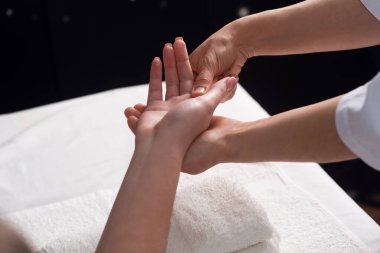 Masseur doing hand massage with oil in spa salon. Spa procedures. relaxing, wellness hand massage. Body care concept. Close-up view. Female hand close-up