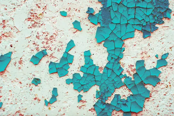 stock image Macro texture of cracked paint on the surface. Vintage background in trendy red and turquoise colors. detailed texture detailed texture. large volumetric cracks in the old painted surface