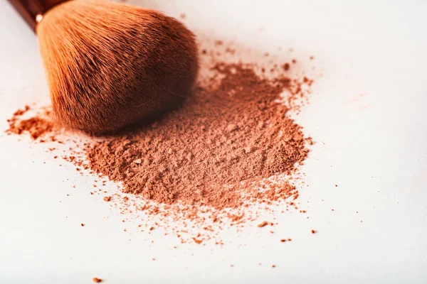 stock image crumbly compact make-up powder in a nude tone with a large powder brush on a white background. Macro, close-up. Copy space, place for text, Cosmetics concept