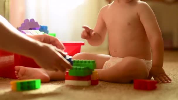 Cute Kid Builds Tower Plastic Constructor His Mom Mom Cares — Stock Video