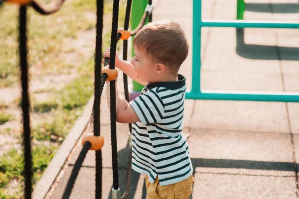 stock image A cute little European-looking boy doing sports on the playground. A healthy lifestyle.