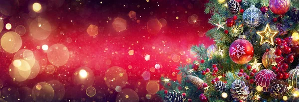 Christmas Tree Red Shiny Background Ornaments Pew Branches Glittering Defocused — 스톡 사진