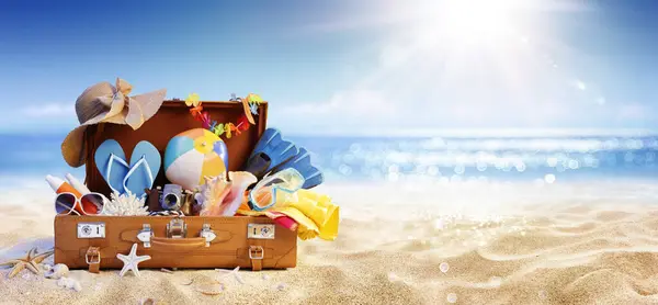 Summer Beach Preparation Suitcase Accessories Sand Defocused Glittering Sea Travel Stock Photo