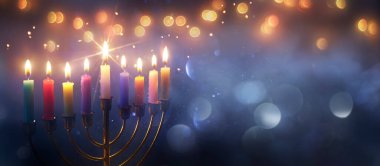 Hanukkah Menorah - Burning Candles With Glittering In Abstract Defocused Background clipart