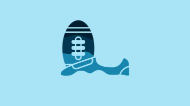 Blue Soccer or football shoes with spikes icon isolated on blue background. American football boot and ball. 4K Video motion graphic animation.