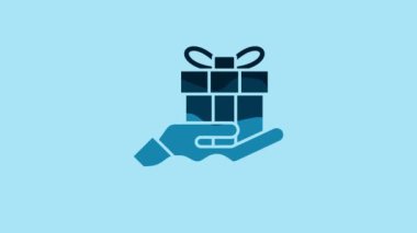 Blue Gift box in hand icon isolated on blue background. Merry Christmas and Happy New Year. 4K Video motion graphic animation.