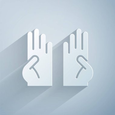 Kağıt kesiği, gri arka planda izole edilmiş lastik eldiven ikonu. Lateks el koruması işareti. Ev işi temizlik ekipmanları sembolü. Kağıt sanatı tarzı. Vektör.