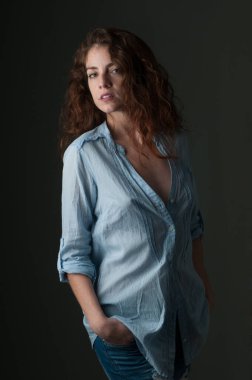 young redhead female model on plain background with copyspace