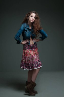 young redhead female model on plain background with copyspace