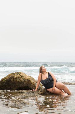 real woman with real body representative of diversity in a coastal area under the sun