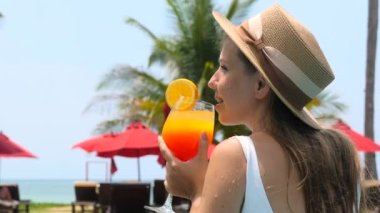 Happy woman on summer trip or adventure. Young traveller girl in swimming pool in beautiful sea resort. Vacation, travel, tropical holidays concept. Khao Lak, Thailand.