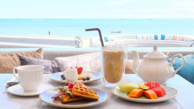 Beautiful morning on beach of beachfront hotel breakfast. Delicious meal with seaview. Relax and enjoy ambiance of ocean and sound of waves. Beach, vacation, travel, resort