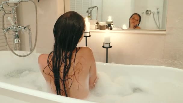 Piękna Młoda Kobieta Biorąc Relaksującą Kąpiel Bąbelkową Domu Świecą Widok — Wideo stockowe