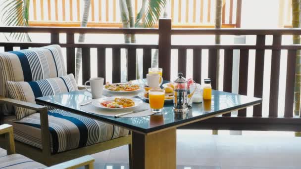 新鲜的早餐自助餐 有各种食物和果汁 热带酒店背景为棕榈树 奢华假期早餐 — 图库视频影像