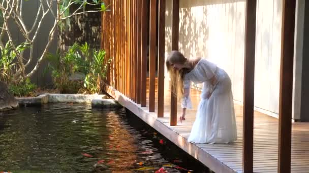 Woman Enjoying Luxurious Spa Experience Slow Motion Surrounded Serene Fish — Video Stock