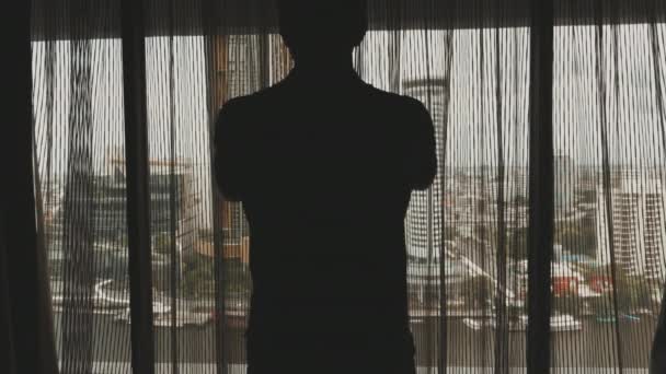 Man Silhouette Opening Curtains Hotel Room Taking Cityscape View Tourist — Stockvideo