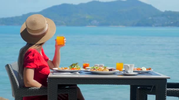 지방에서 레스토랑이나 호텔에서 여자가 식사를 즐기고 있습니다 바다의 아름다운 풍경이죠 — 비디오