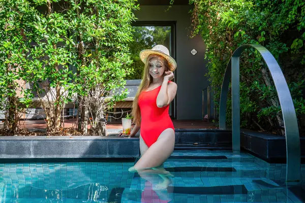 Sun-kissed model, poolside, flaunting her tan and swimwear fashion. A luxurious summer retreat in Thailand.