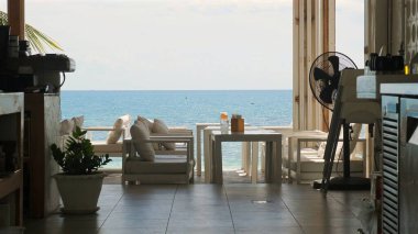 Manzaralı deniz manzaralı rahat bir kafe, atmosferi cezbedici ve tatil için rahatlatıcı bir ortam, boş zaman ve uzak çalışma, mavi gökyüzü ve sakin sularla sakin bir yaz günü. Rahatlama ve Seyahat