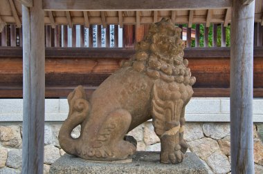 A guardian dog sitting in front of Motoise Kono Jinja. Miyazu Japan clipart