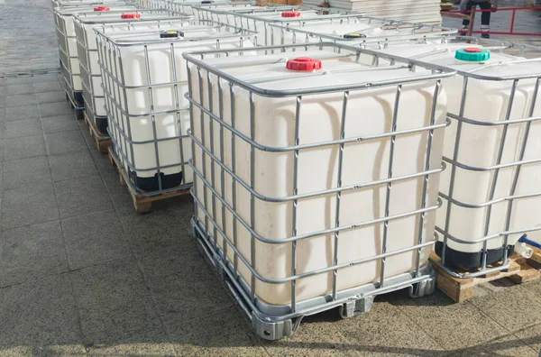 stock image Lots of cube water tanks. 1000 litres containers piled outdoors