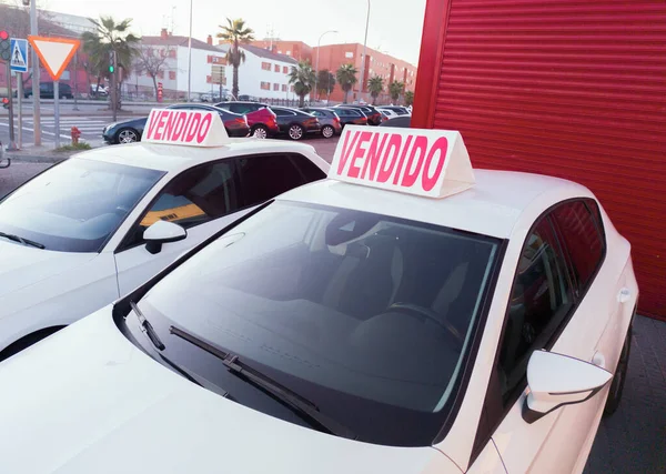 Second-hand cars with sold sign over. Boom in the purchase of used cars in Spain