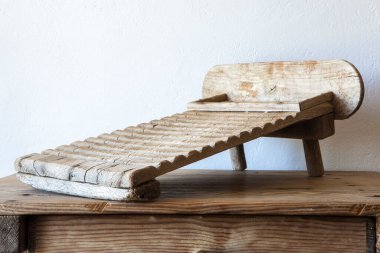 Old wooden washboard. Displayed over wooden table