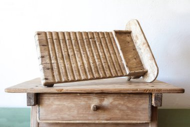Old wooden washboard. Displayed over wooden table
