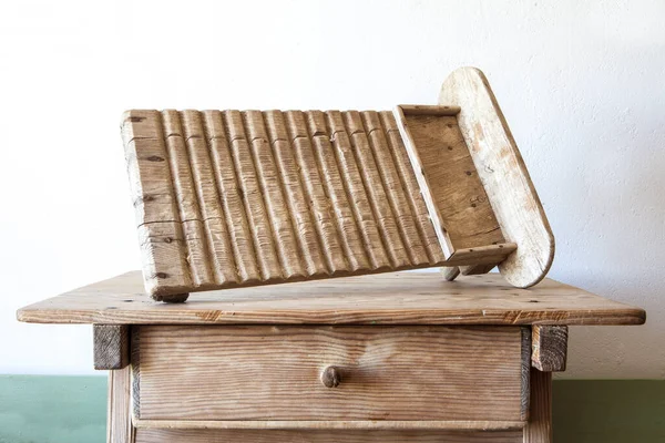 Old wooden washboard. Displayed over wooden table