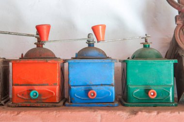 Old manual colorful coffee grinders. Country style background