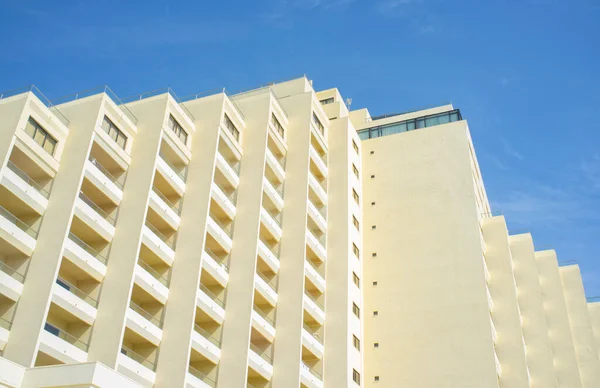 stock image Clear block of flats over blue sky. Seventies beachfront architecture