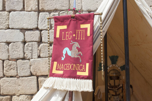 Merida, Spain - June 4th, 2023: Vexillum, roman military standard beside legionary officer tent. Emerita Ludica Festival 2023, Merida, Spain