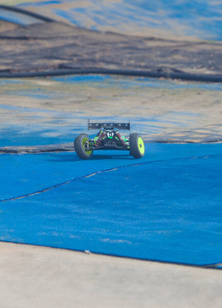 Merida, Spain - Jan 28th, 2024: Extremadura 1/8tt gas Championship RC Car. Cars making a curve over blue turf