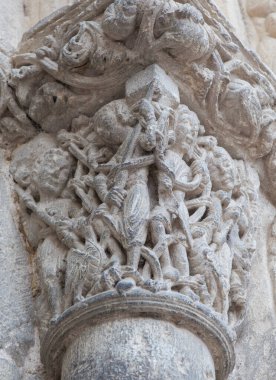Church of San Miguel portal. Estella-Lizarra town, Navarre, Northern Spain. Young fighters with spears clipart
