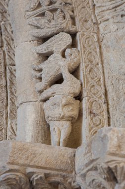 Romanesque portico of Church of Crucifijo, Puente La Reina, Navarre, Spain. Man-eating monster clipart