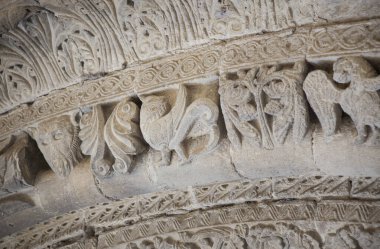 Romanesque portico of Church of Crucifijo, Puente La Reina, Navarre, Spain. Decorated archivolt with griffin clipart