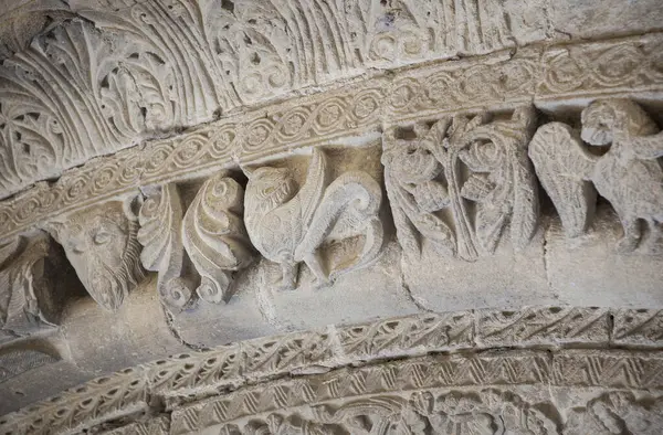 stock image Romanesque portico of Church of Crucifijo, Puente La Reina, Navarre, Spain. Decorated archivolt with griffin